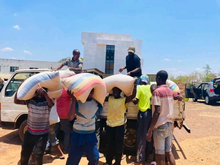 Cha Cha distributes maize to car wash attendants